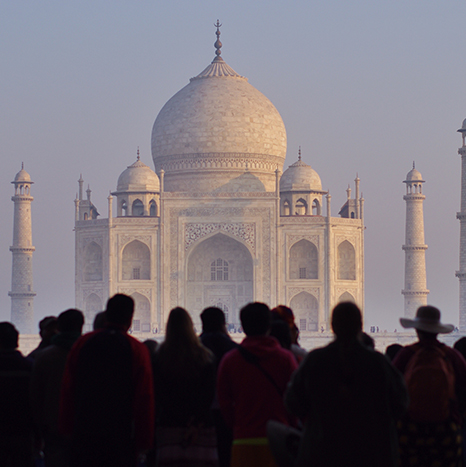 A group of people standing in front of the taj mahal.