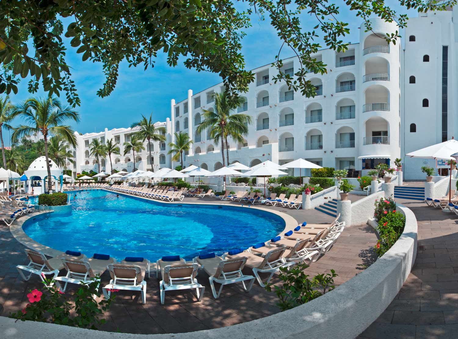 A large pool with many chairs around it