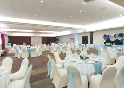 A banquet hall with many tables and chairs