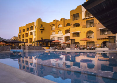 A pool with many buildings in the background