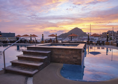 A pool with steps and stairs leading to the top of it.