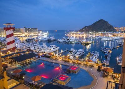 A large pool of water with many boats in the background.