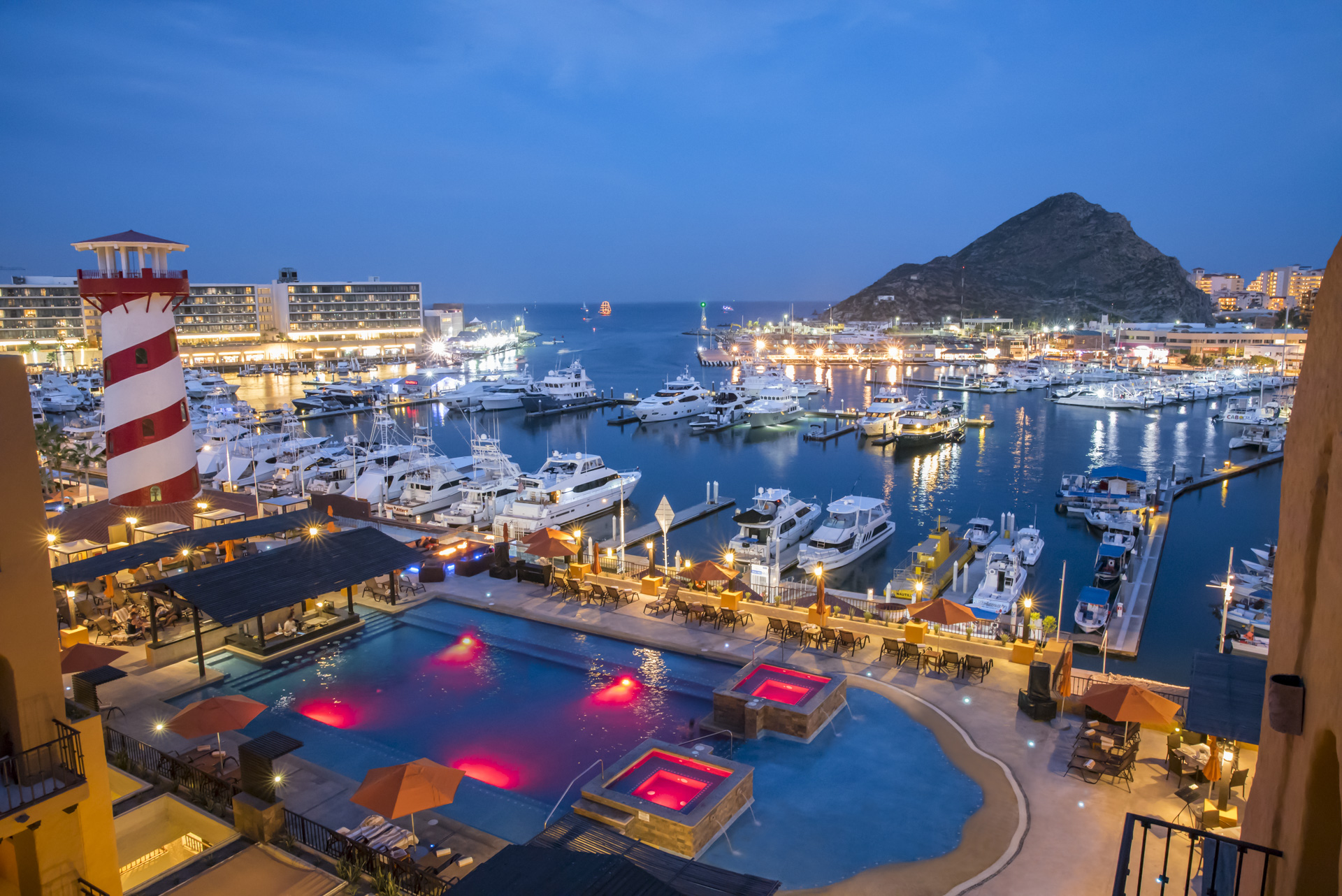 A large pool of water with many boats in the background.