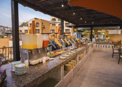 A buffet line with many plates and bowls